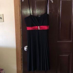 Black cocktail dress with red accent